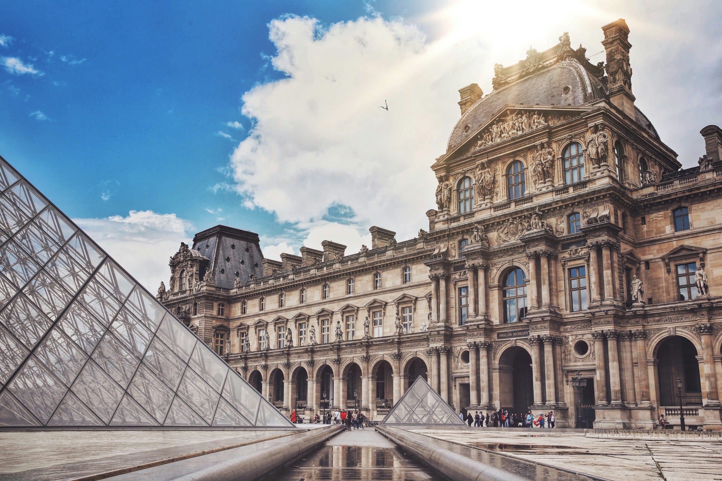 The Louvre Museum with its iconic glass pyramid in Paris